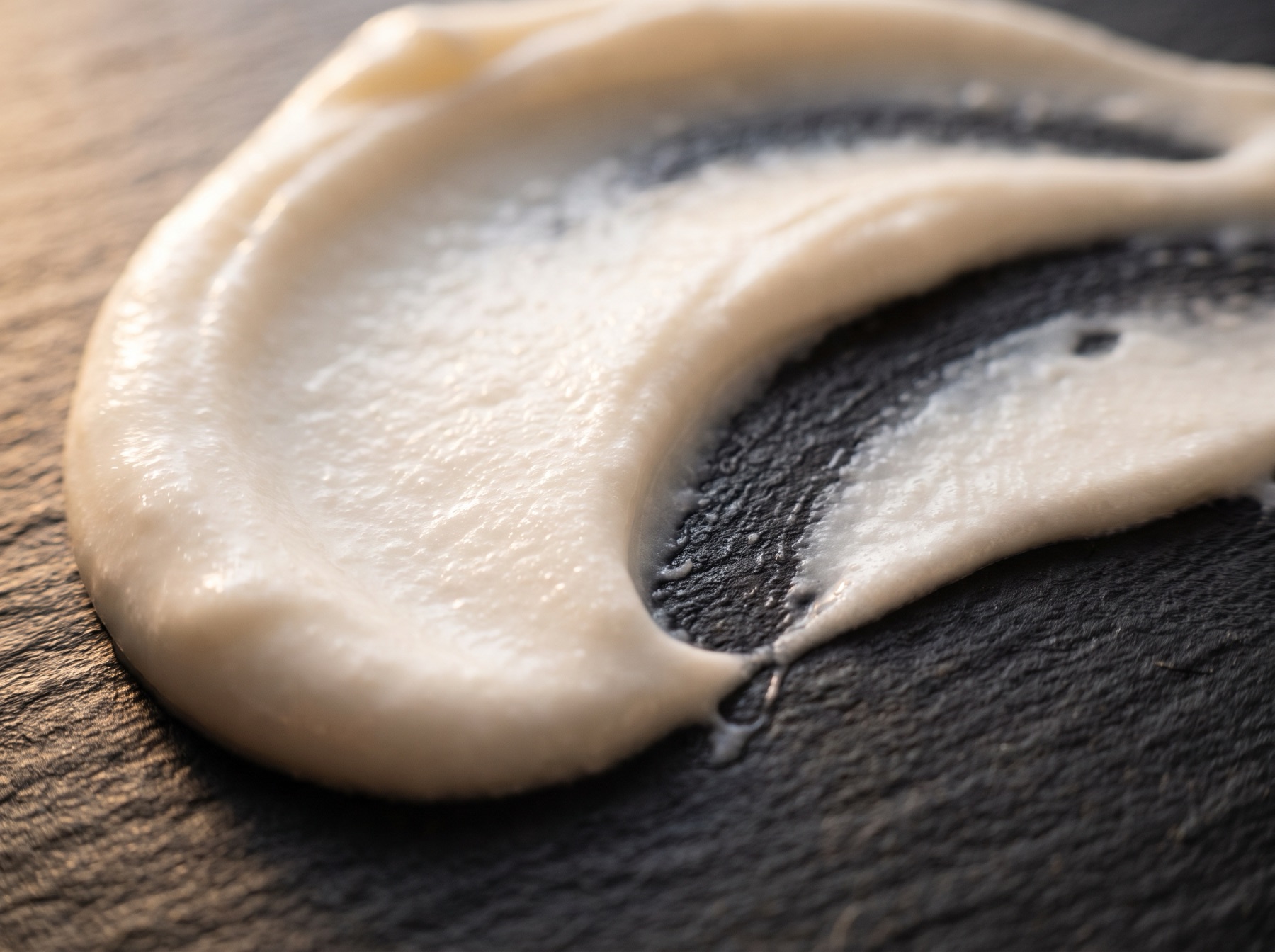 Macro of thick white cream with a fingertip swipe